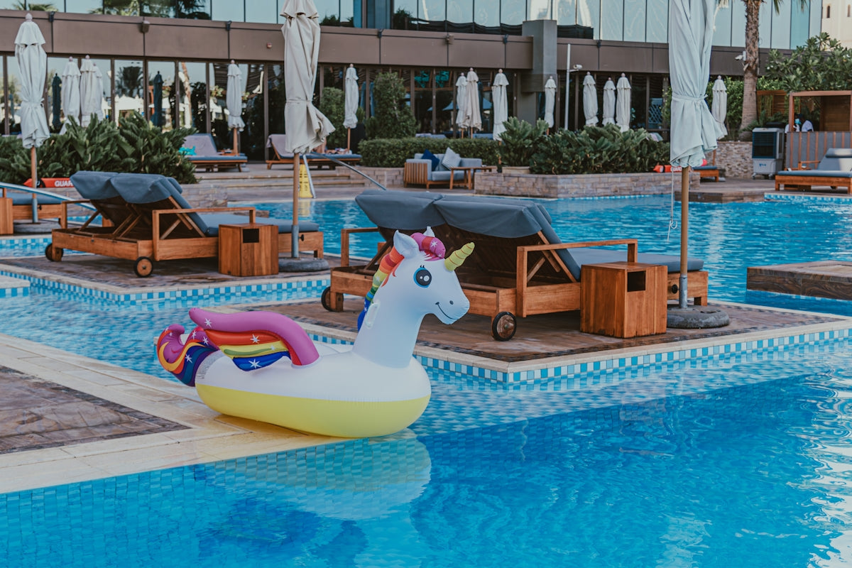 An inflatable unicorn float in the middle of a swimming pool