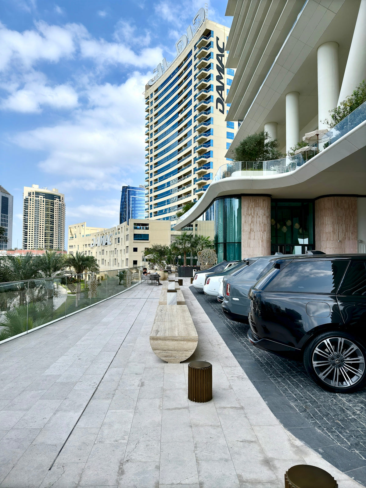 Modern buildings line a waterfront promenade in dubai.