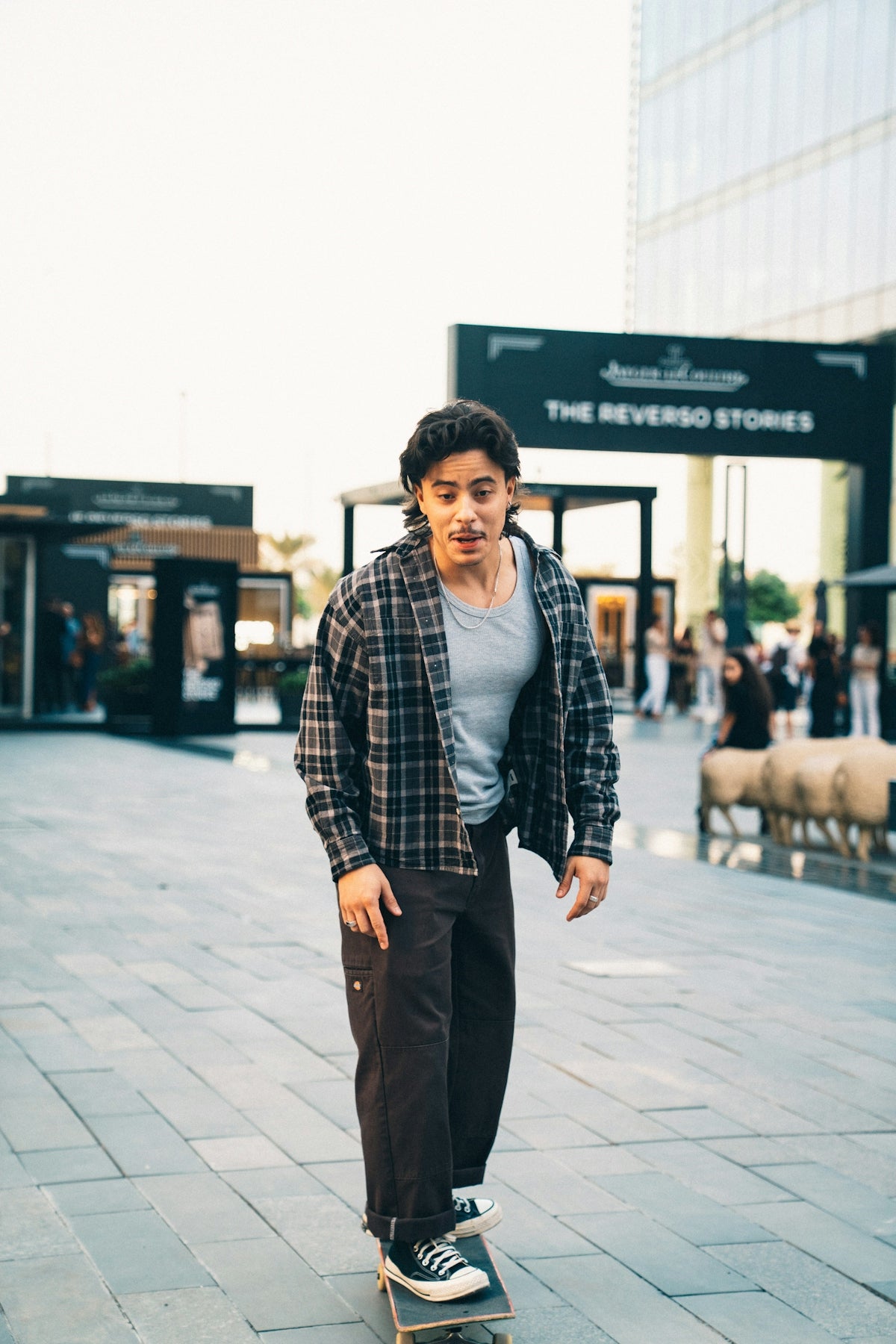 A young man rides a skateboard outdoors.