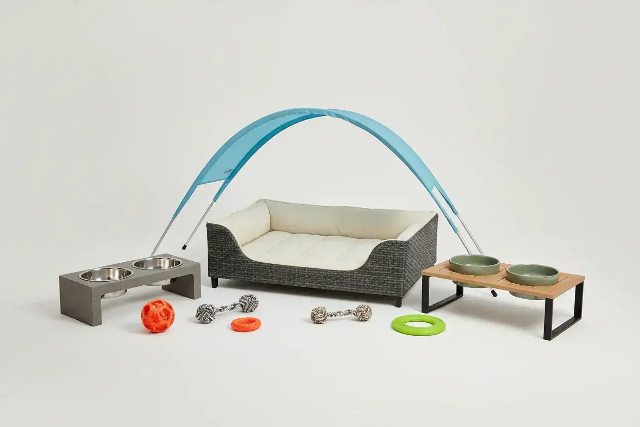 Modern grey pet bed with blue canopy, feeding stations, and dog toys at The Outdoor Furniture Market