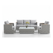Grey wicker outdoor patio furniture set with sofa, armchairs, and glass coffee table at The Outdoor Furniture Market