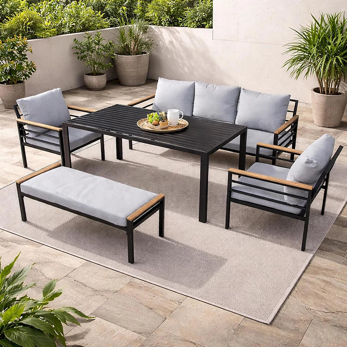 Black aluminum outdoor sofa set with waterproof cushions, six-seater garden furniture from The Outdoor Furniture Market.