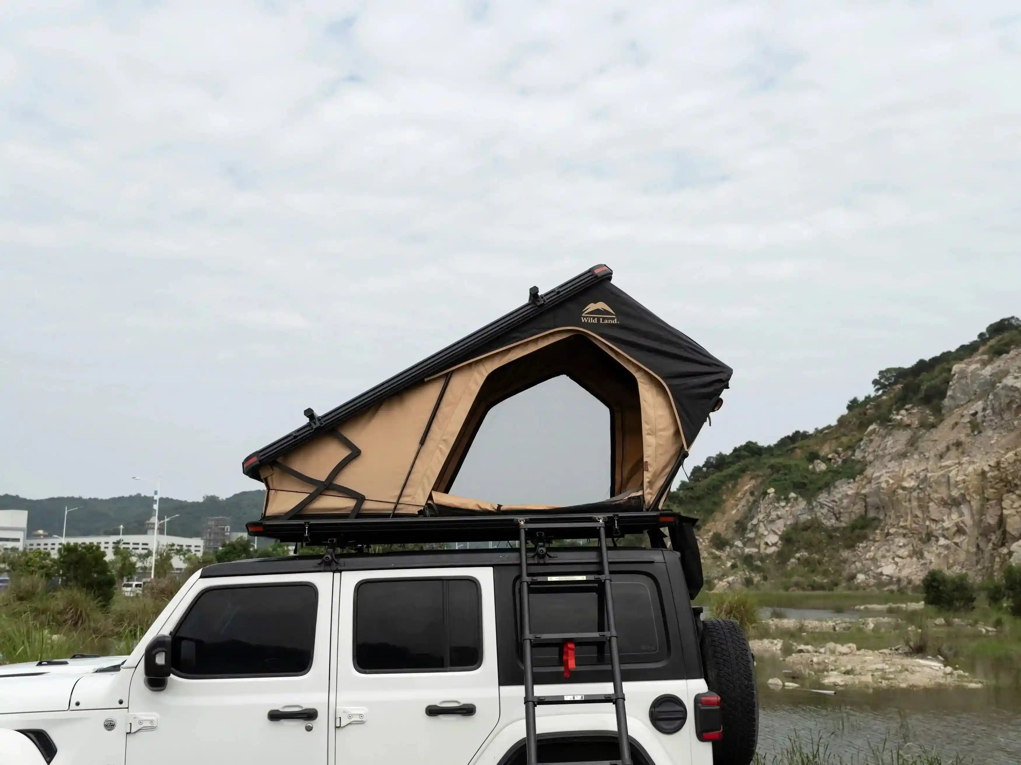 Triangle hard shell car roof tent from The Outdoor Furniture Market, mounted on a vehicle for easy camping setup.