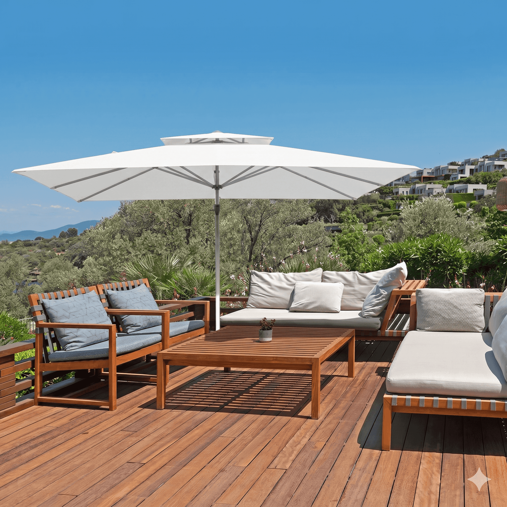 Outdoor patio set with wooden furniture, cushions, and a large umbrella on a wooden deck with a scenic background.