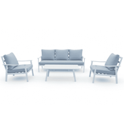 White aluminum outdoor sofa set by The Outdoor Furniture Market, featuring cushioned seats and a modern patio design.
