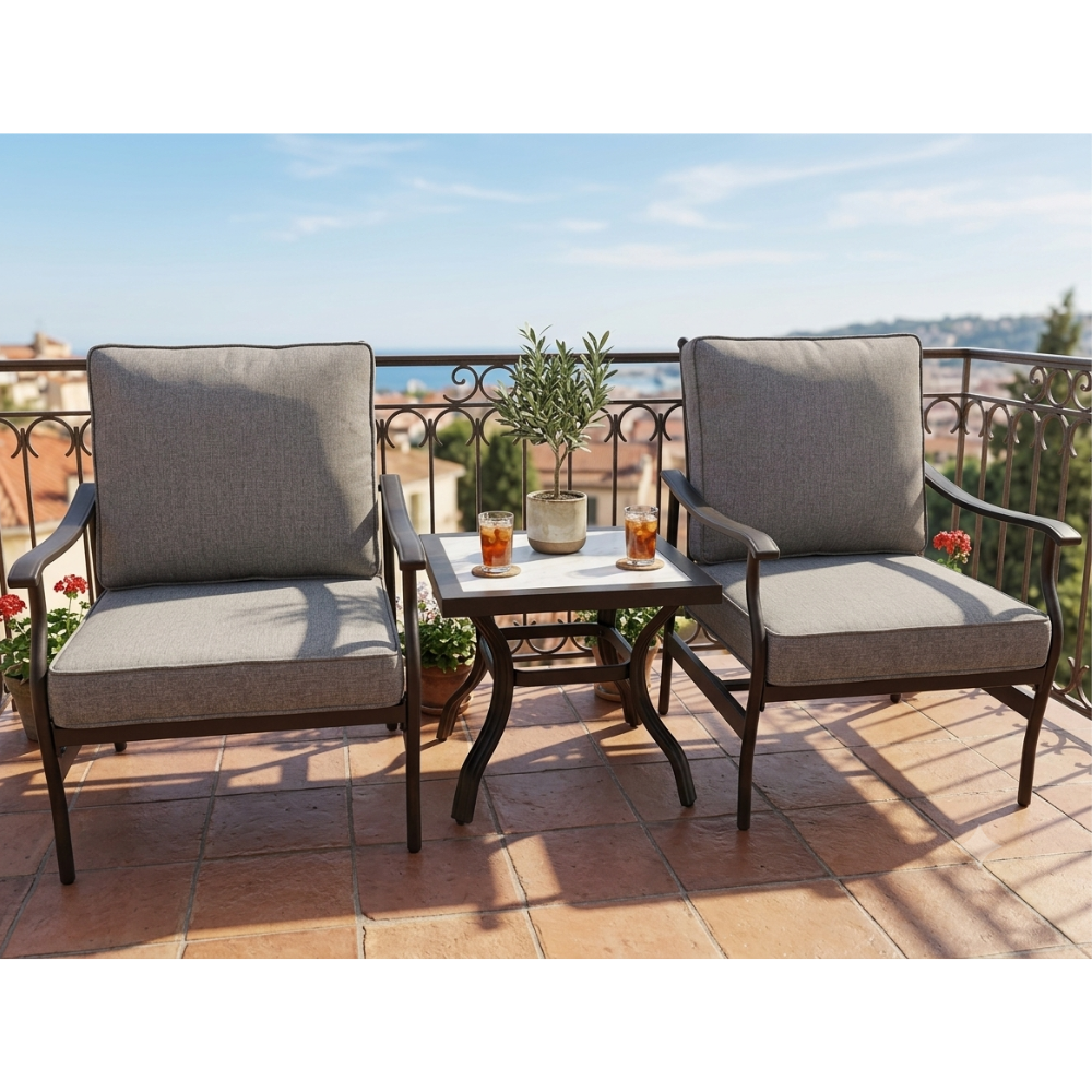 Two grey cushioned outdoor armchairs with a small side table on a terrace at The Outdoor Furniture Market