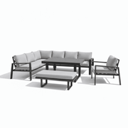 Modern L-shape outdoor sofa set by The Outdoor Furniture Market with weather-resistant cushions and a slatted dining table.