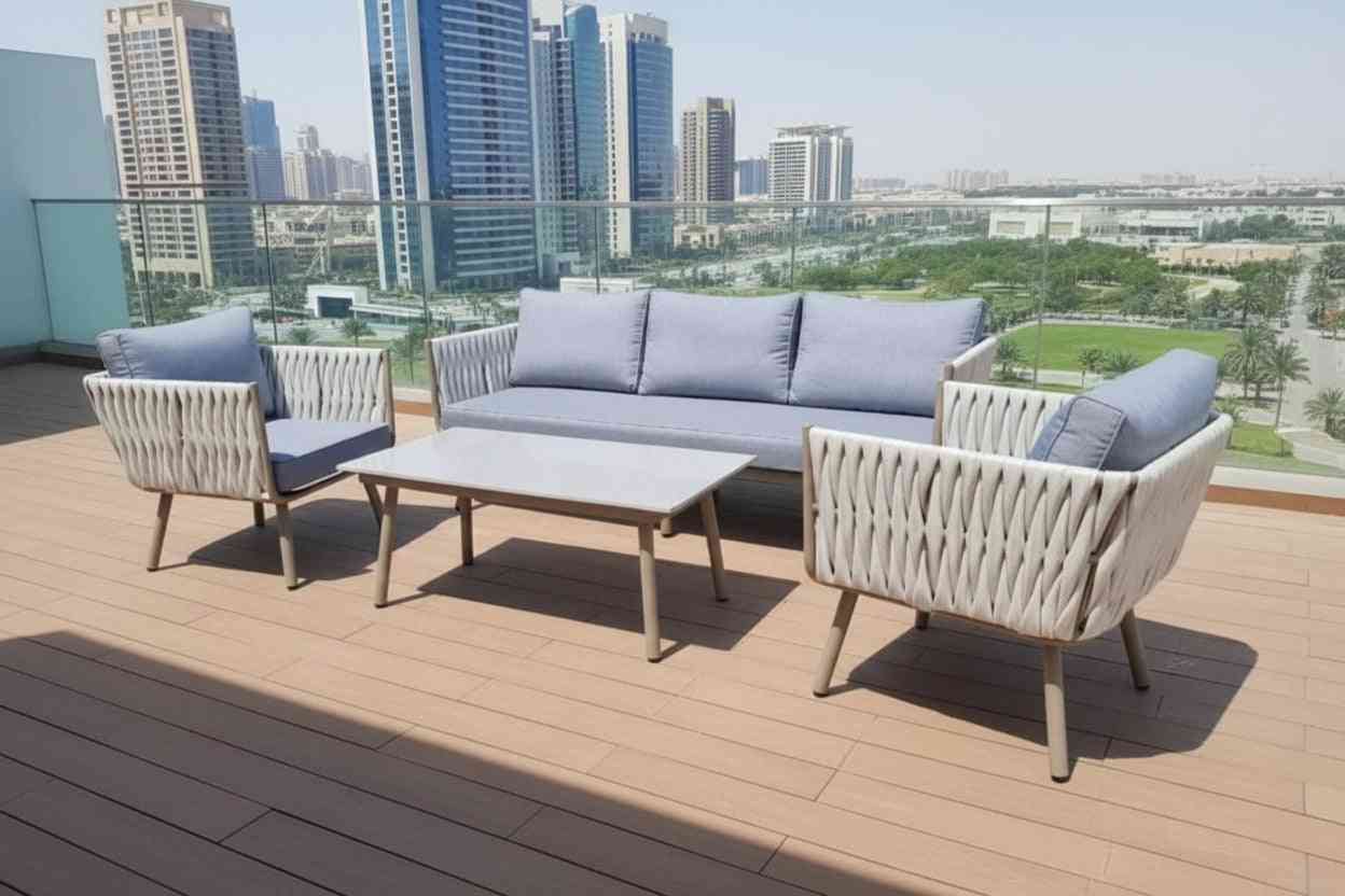 Modern outdoor lounge set with patio sofa and stylish coffee table by The Outdoor Furniture Market, set on a patio.