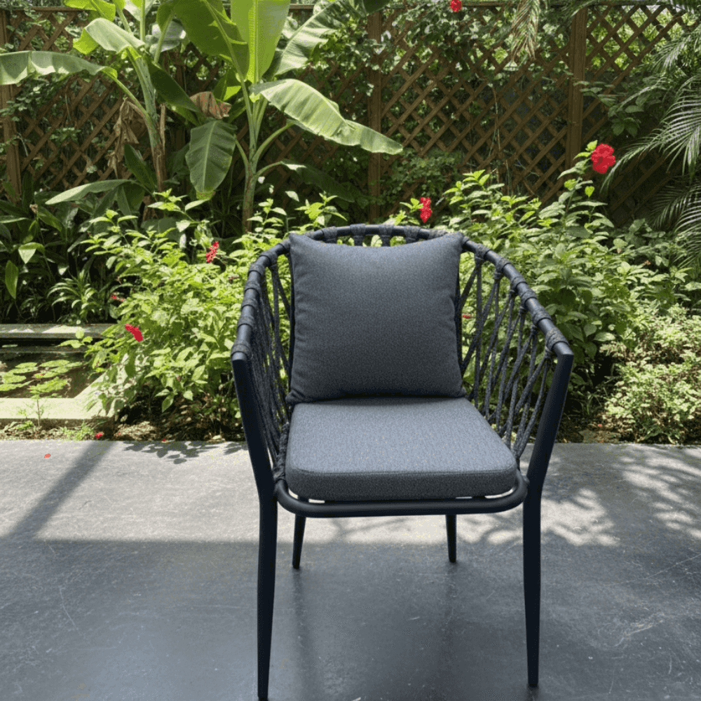 Modern outdoor rope armchair with aluminum frame and weatherproof cushions, ideal for outdoor dining and lounging.