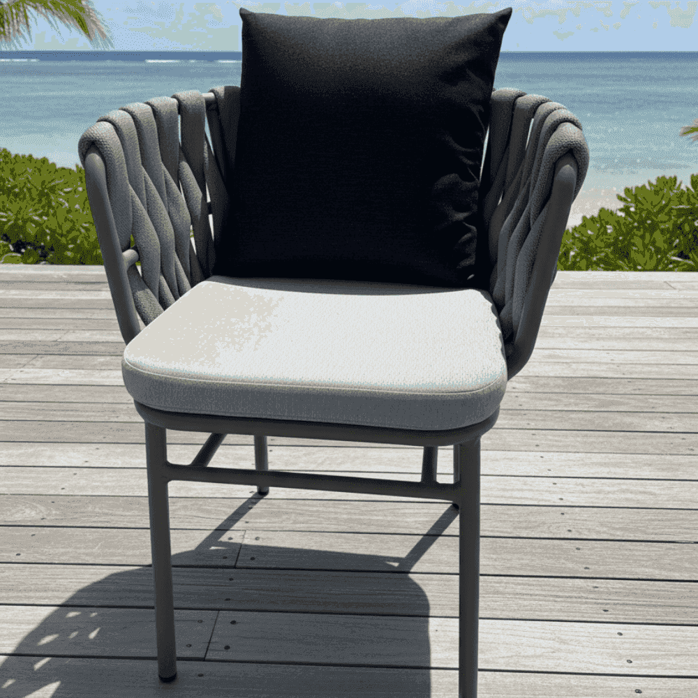 Modern outdoor rope-weave dining chair with aluminum frame and weatherproof cushions, part of a stylish dining set.