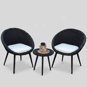 Black wicker outdoor chair set with white cushions and small side table from The Outdoor Furniture Market