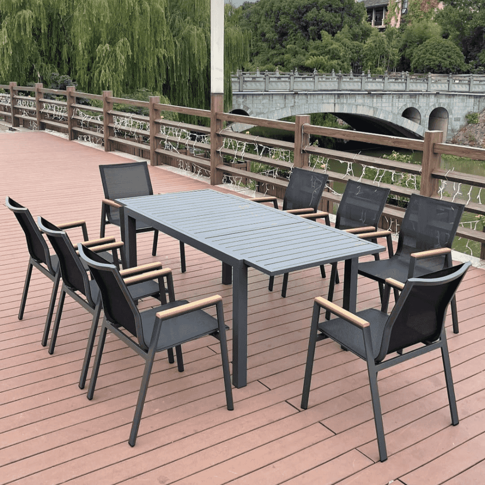 Outdoor dining set with wood-look armrest table and chairs from The Outdoor Furniture Market, showing a stylish patio arrangement.