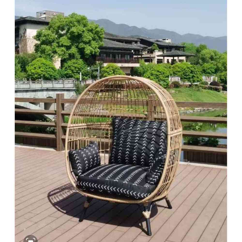 Oversize wicker egg chair by The Outdoor Furniture Market with a rounded, cozy design and woven wicker texture.