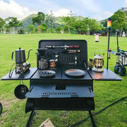 Black portable foldable camping table with multi-storage box and stand, featuring a 50L capacity, by The Outdoor Furniture Market.