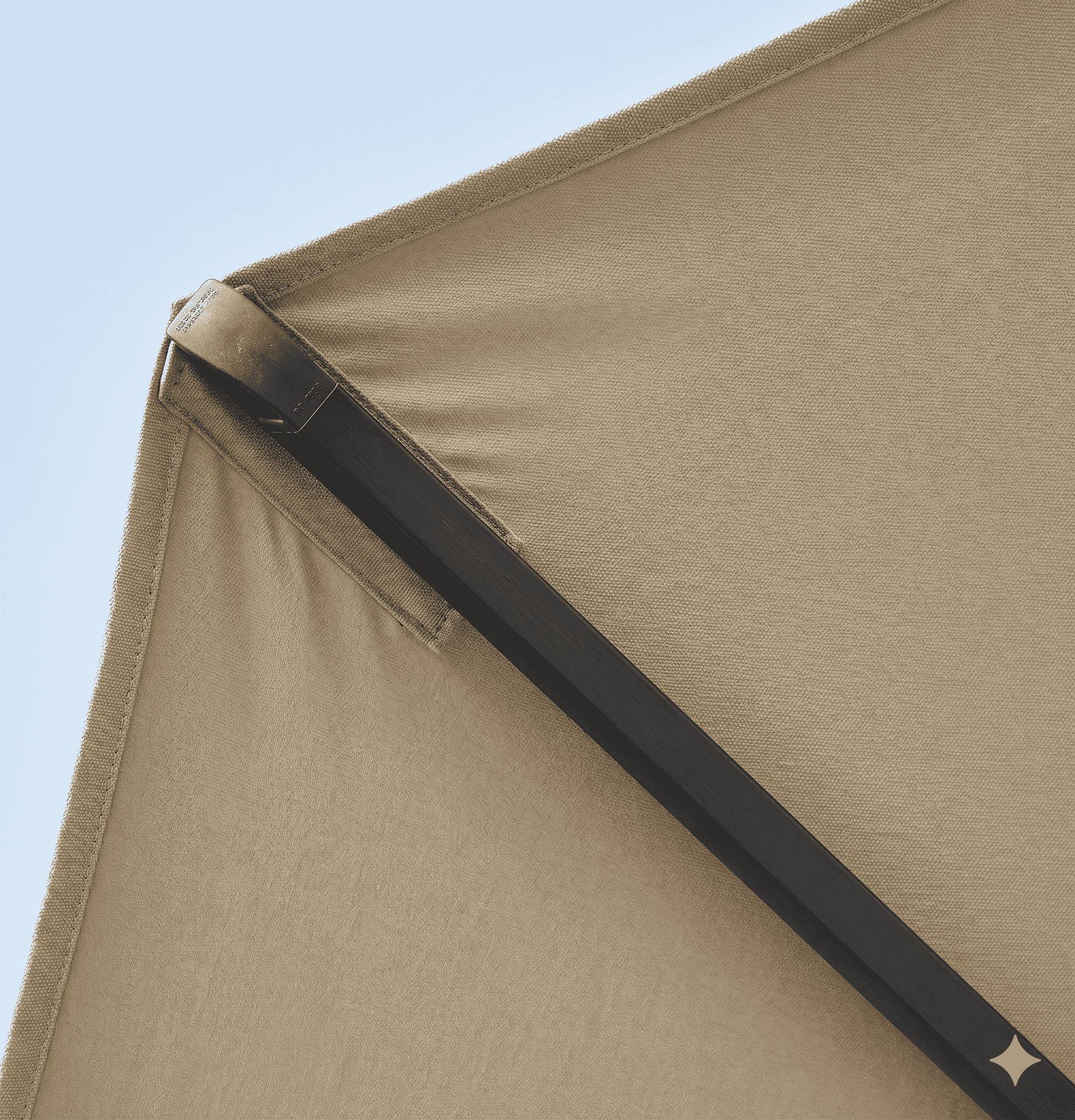 Close-up of a beige tent corner with a clear blue sky background