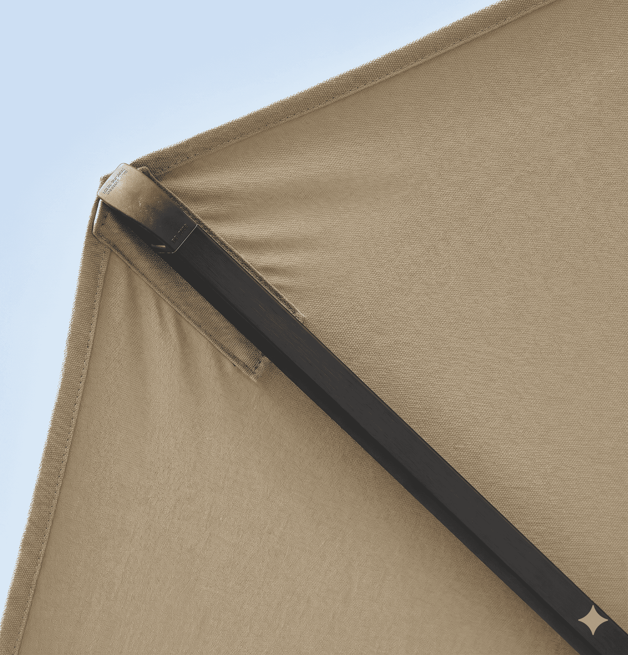 Close-up of a beige tent corner with a clear blue sky background