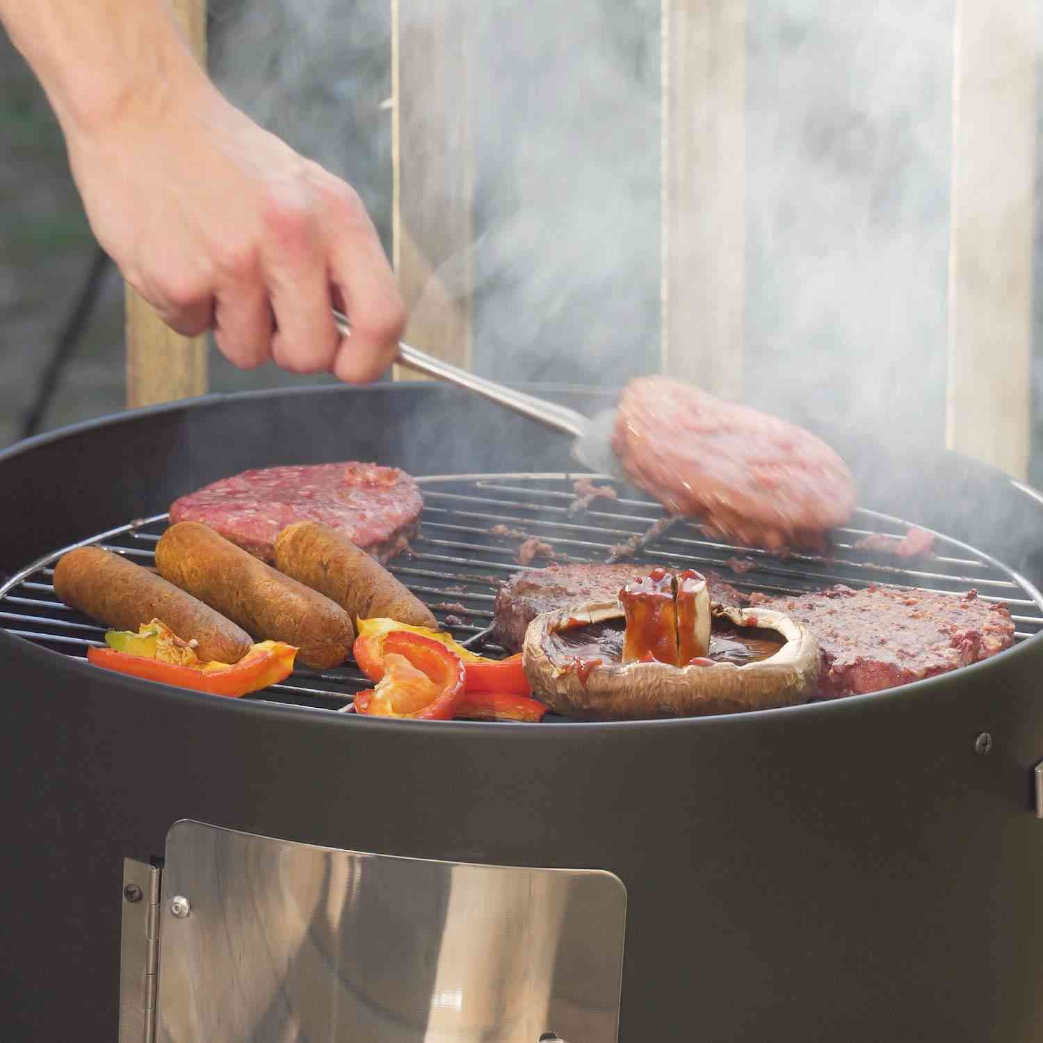 Realcook vertical charcoal smoker with a multi-layer design, large 636 sq.in cooking surface, ideal for outdoor BBQ grilling and smoking.