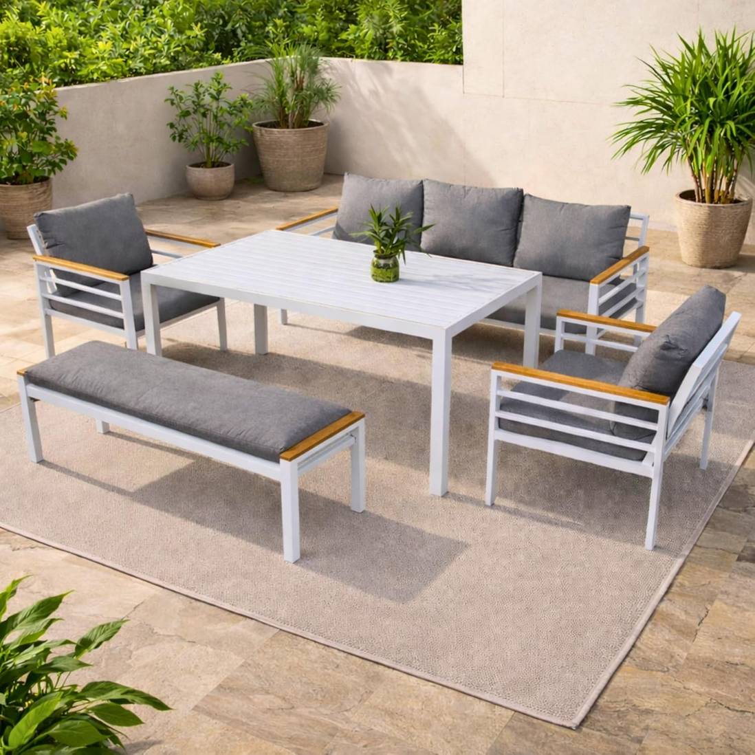 White frame 7-seater aluminium outdoor sofa set with grey cushions and slatted table by The Outdoor Furniture Market.