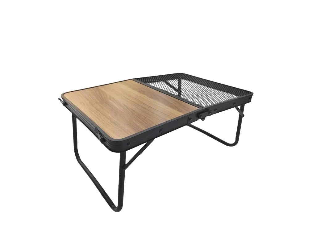 Portable Casa Fiora folding camping table with carry handle set up outdoors on grass.