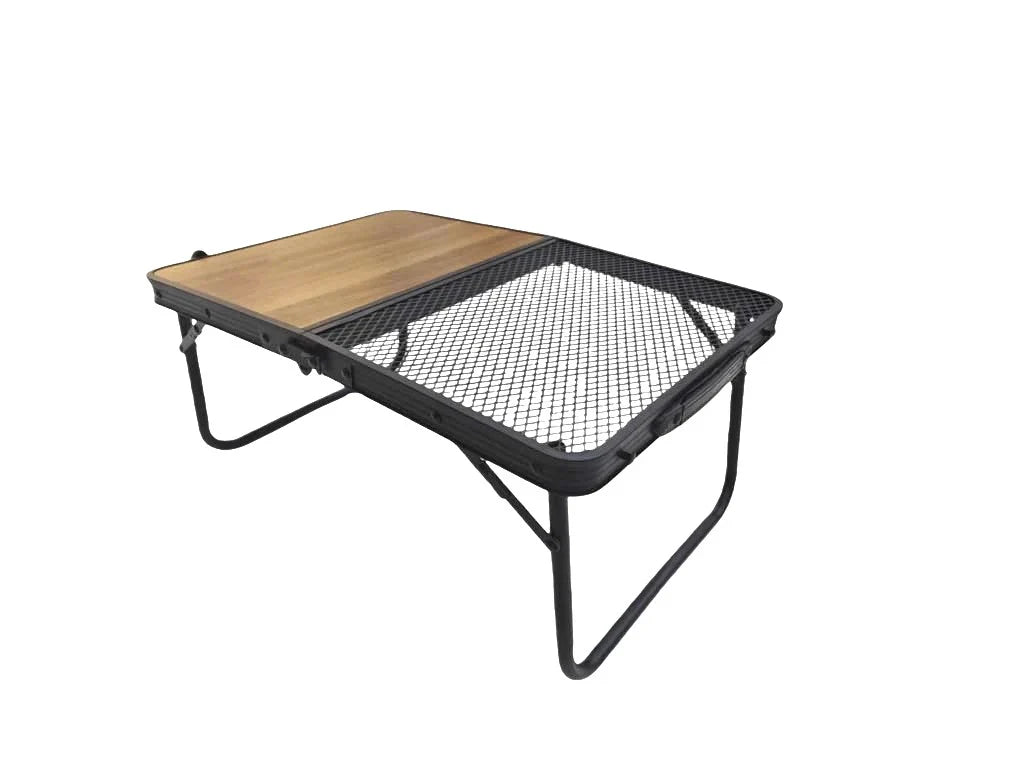 Portable folding camping table by Casa Fiora with a carry handle, set up outdoors on grass.