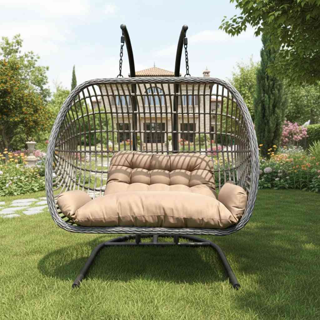 Two-person outdoor patio swing chair with rattan frame and plush cushions, perfect for relaxing in the outdoor lounge area.