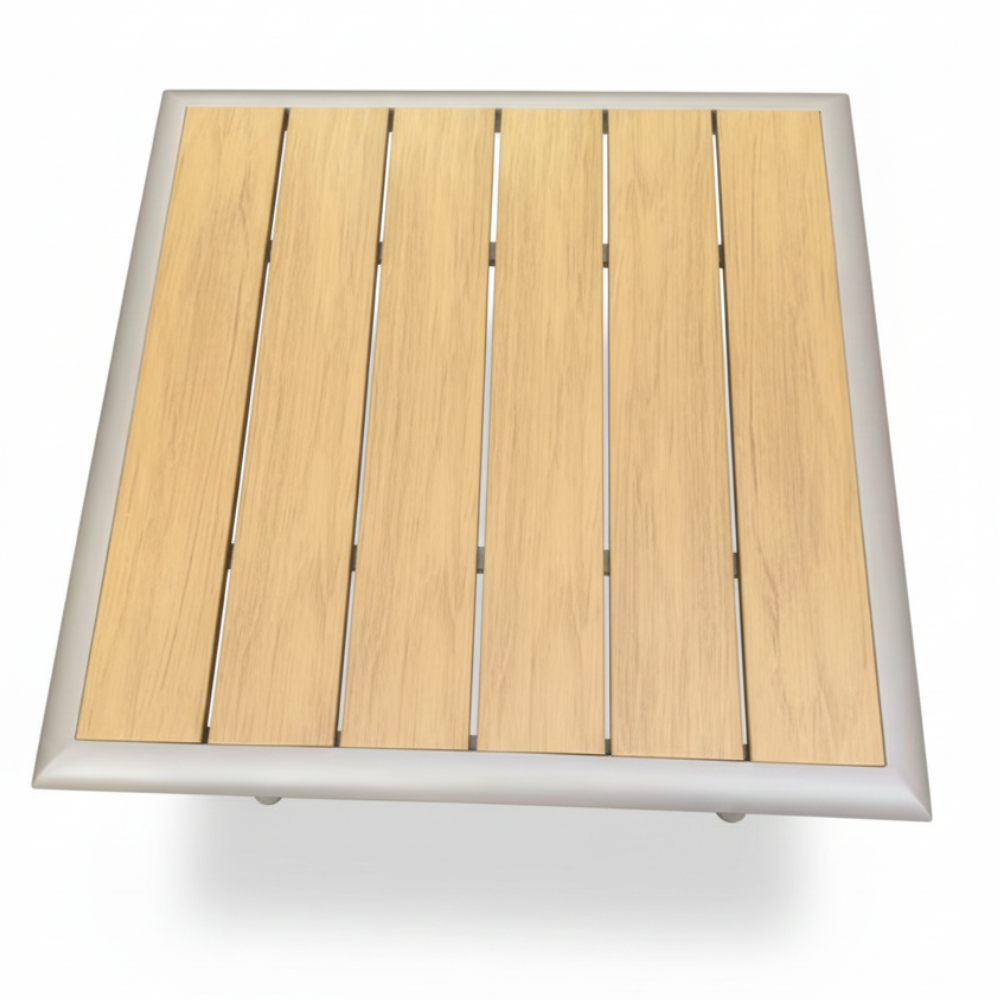 CasaFiora LuxeAlu WPC outdoor dining table featuring a sleek design and durable materials in a sunlit garden setting.